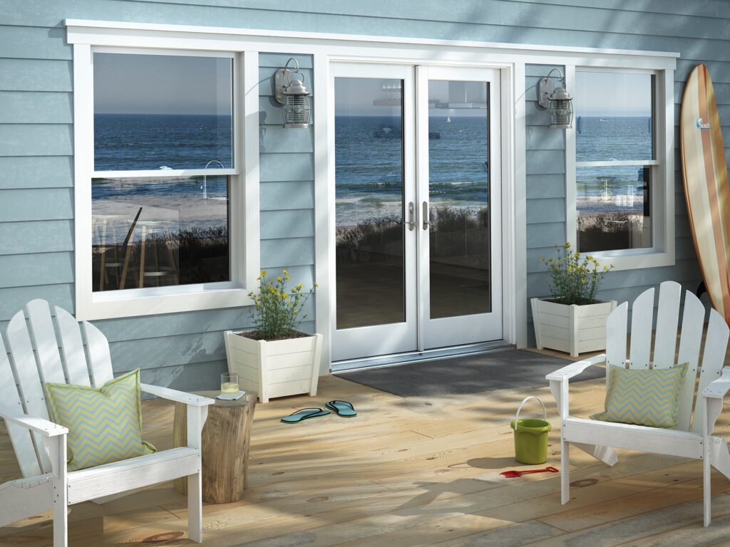 White French doors and double-hung windows overlooking the ocean